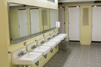 ISR bathroom with sinks, mirrors and shower stalls