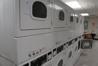 Laundry room with stacked dryers