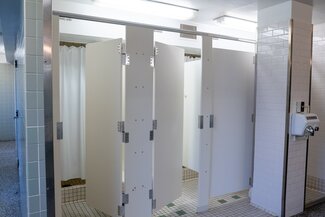 Communal bathroom with private shower stalls
