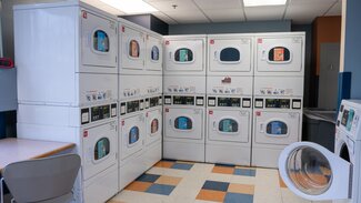 Weston laundry room with stacked dryers
