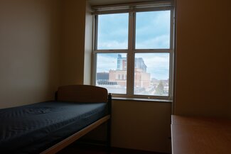 Single bed with window looking out across Memorial Stadium