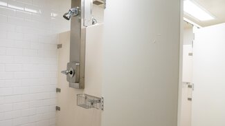 Communal bathroom with shower stalls
