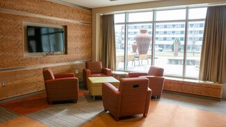 Wassaja Main Lounge with chairs, table, tv and large window