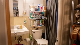 Bathroom with toilet, sink, shower and toiletries