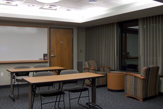 Multipurpose room with tables, chairs, and whiteboard 