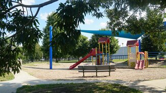 Playground with brightly colored play structures and sun shield