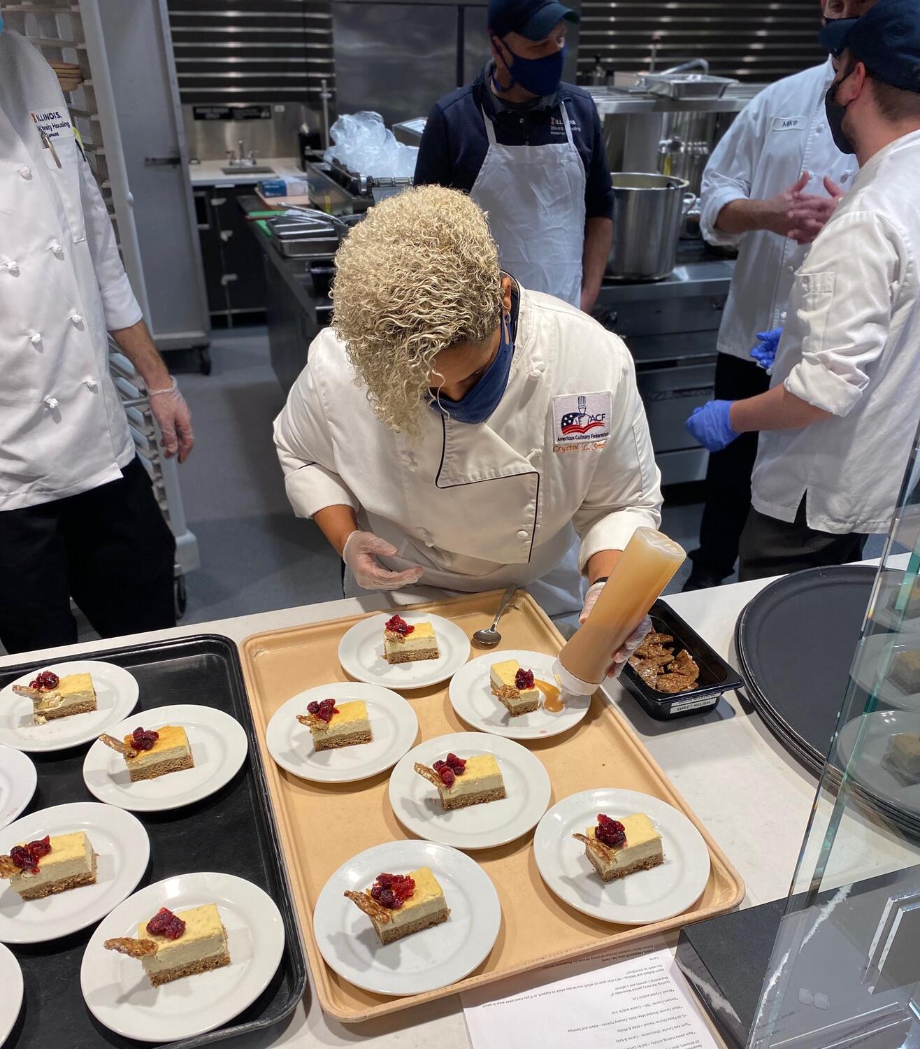 Chef Crystol Smith puts the finishing touches on dessert plates.